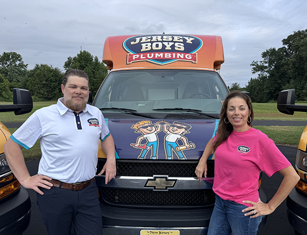 Jersey Boys owners Bob and Val in front of fleet trucks.